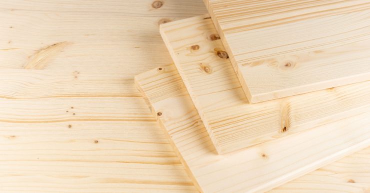 Des planches de construction en bois clair empilées les unes sur les autres