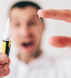 Focus sur les mains d'un homme avec de la colle sur les doigts