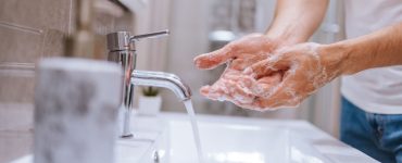 Gros plan sur un homme se lavant les mains dans le lavabo
