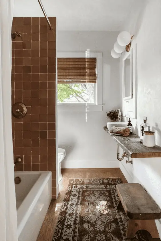 Une jolie salle de bain décorée avec un tapis vintage, des fleurs et des appliques design