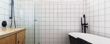 Salle de bain en noir et blanc avec une vasque en bois