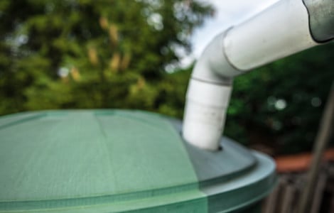 Récupération de l'eau de pluie par les gouttières dans une cuve verte