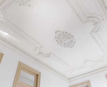 Vue sur le plafond blanc orné de belles moulures