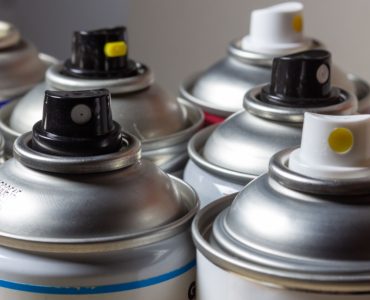 Plusieurs bombes aérosols pour la peinture posées l'une à côté de l'autre