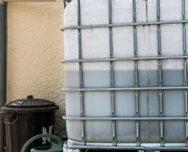 Une cuve de récupération d’eau de pluie fixée par des cadres en métal