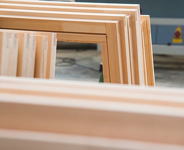 Plisoeirs fenêtres en bois empilées dans un atelier