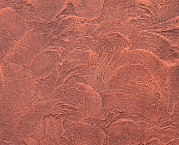 Texture d'un mur en plâtre décoratif rouge