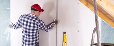 Un homme en casquette pose une cloison