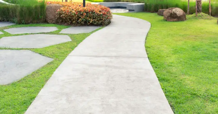 Une allée en béton dans un jardin