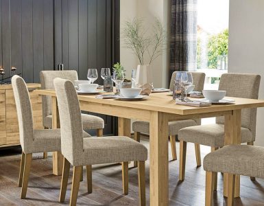 Salle à manger avec table en bois et chaises en tissu gris