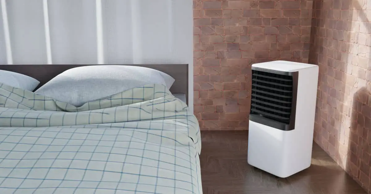 Un climatiseur portable placé à côté d'un lit