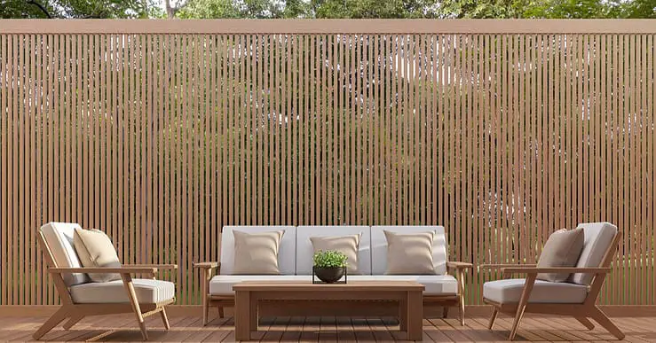 Un salon de jardin en bois avec une brise-vue en fond