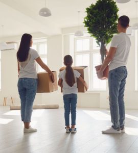 Un jeune couple avec une fille emménage dans un appartement avec leurs cartons