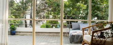 Vue sur un lit à l'extérieur de la maison à travers une baie vitrée