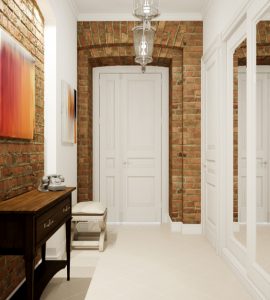 Vue sur un couloir blanc avec des murs en briques et une porte blanche