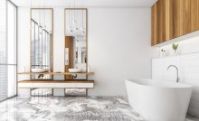 Salle de bain moderne avec des meubles en bois et une baignoire blanche sur le sol en marbre