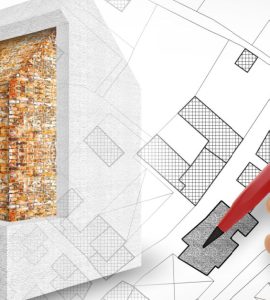 Zoom sur la main d'un homme tenant un crayon et dessinant le plan d'isolation thermique d'une maison
