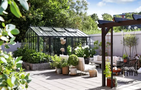 serre en métal et en verre dans le jardin
